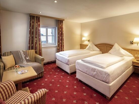 A double room with separate beds and seating
