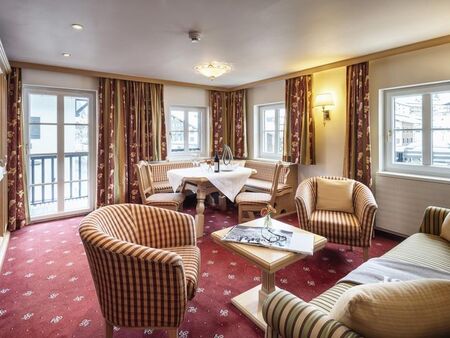 Großes und helles Wohn- und Esszimmer mit Balkon und rotem Teppichboden