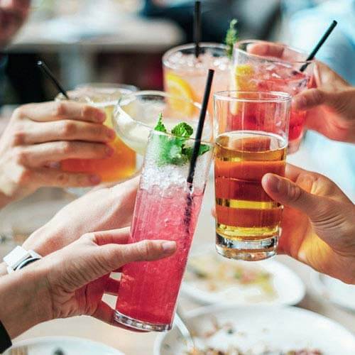 A group toasts with different drinks